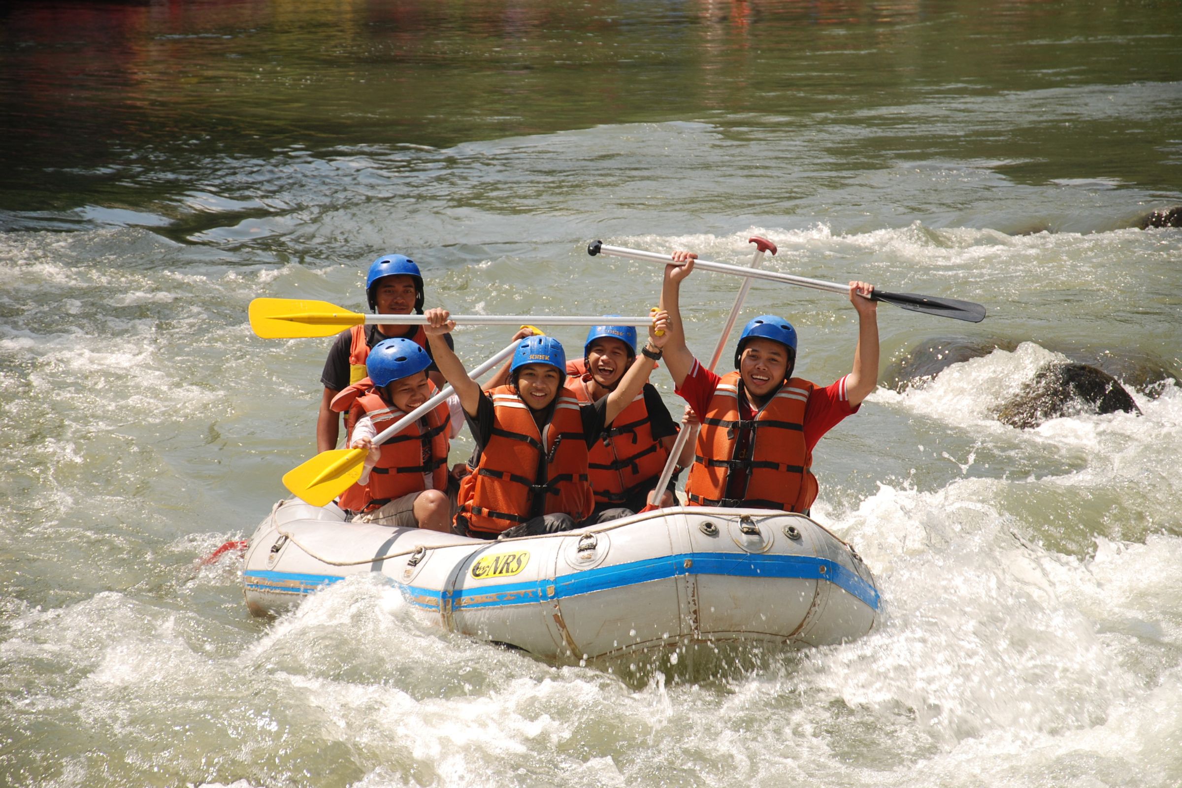 ExploreGear.com | Group rafting adventure with paddles, helmets, and life vests