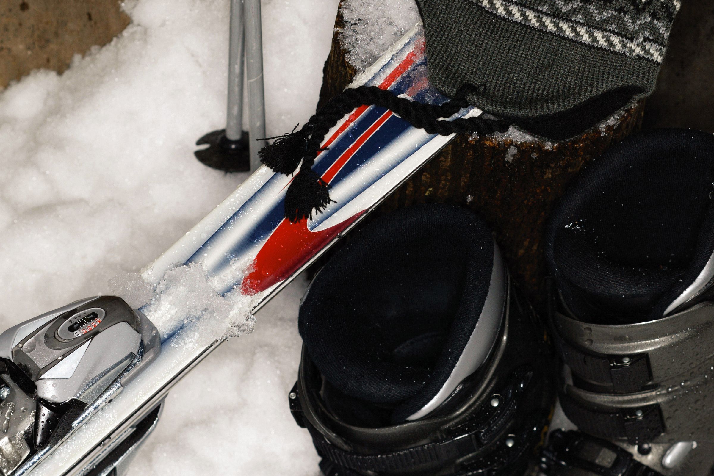 ExploreGear.com | Ski boots, poles, and winter hat on snow.